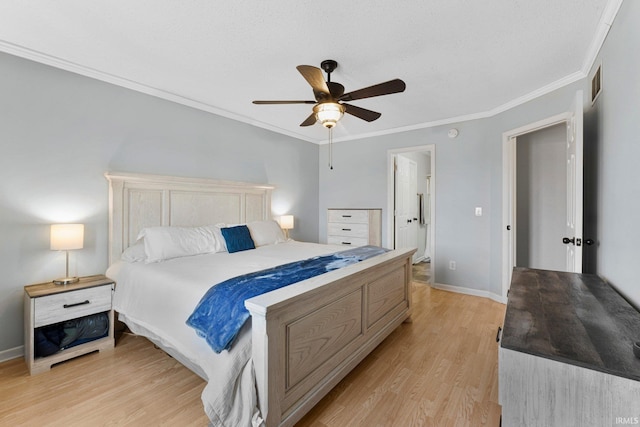 bedroom with ornamental molding, light wood-type flooring, visible vents, and baseboards