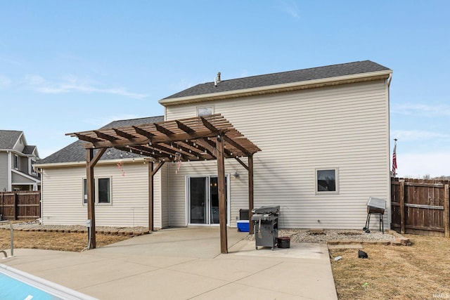 back of property featuring a shingled roof, a pergola, fence, and a patio