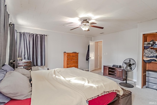 bedroom featuring baseboards, a ceiling fan, and light colored carpet