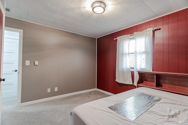 carpeted bedroom with visible vents and baseboards