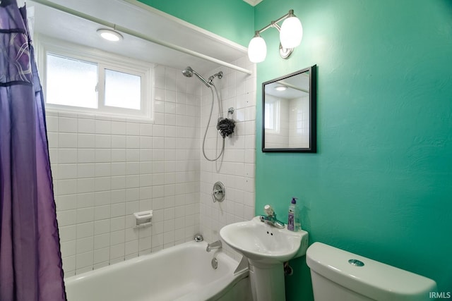 bathroom featuring shower / bath combination with curtain and toilet