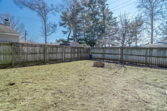 view of yard featuring an outdoor fire pit and a fenced backyard