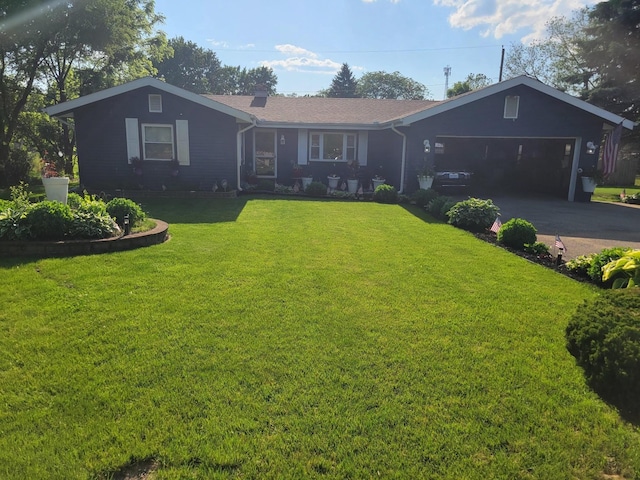 ranch-style home with an attached garage, driveway, and a front yard