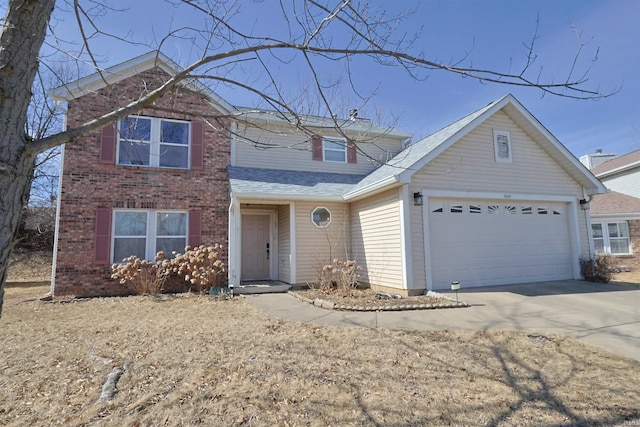 traditional home featuring concrete driveway, brick siding, an attached garage, and roof with shingles