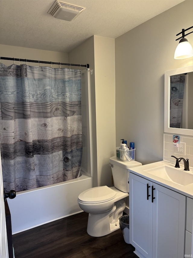 full bath with tasteful backsplash, visible vents, toilet, wood finished floors, and vanity