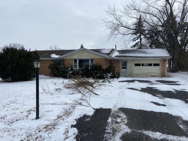 ranch-style house featuring brick siding and an attached garage