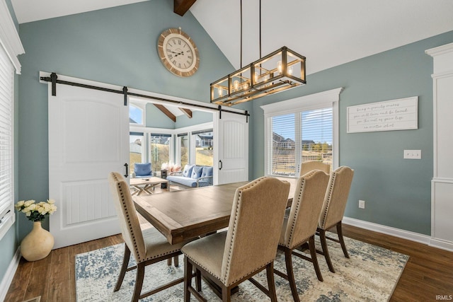 dining area with dark wood-style flooring, beamed ceiling, baseboards, and a barn door