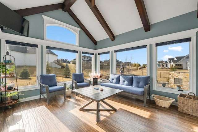 sunroom featuring vaulted ceiling with beams