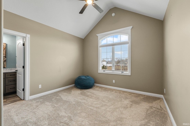 unfurnished bedroom with carpet floors, baseboards, vaulted ceiling, and ensuite bathroom