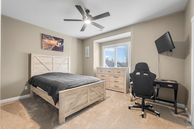 bedroom with baseboards, a textured ceiling, and light colored carpet