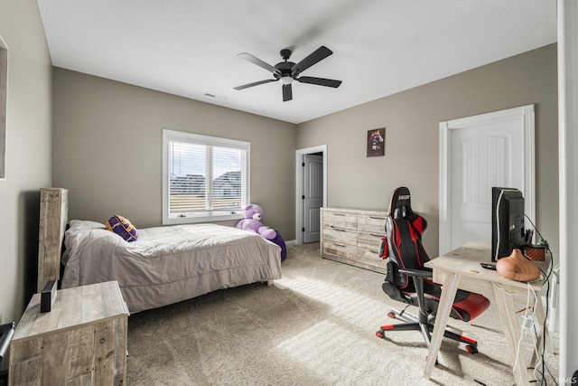 bedroom with light carpet, ceiling fan, and visible vents