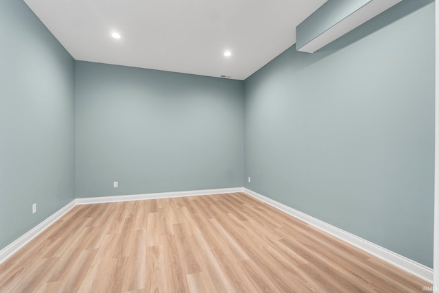 unfurnished room with baseboards, recessed lighting, and light wood-style floors