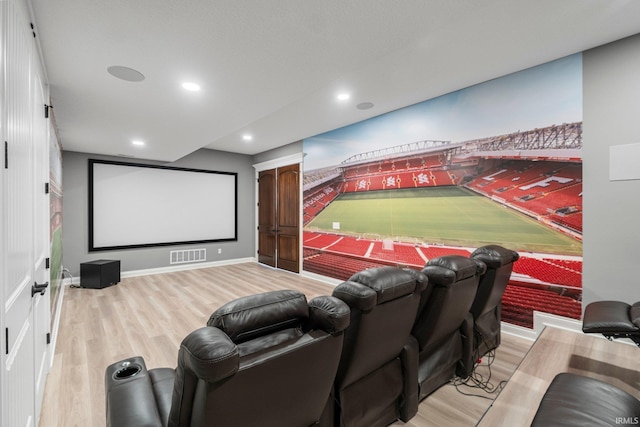 cinema room featuring baseboards, wood finished floors, visible vents, and recessed lighting