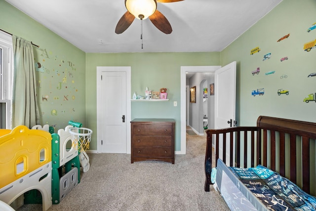 carpeted bedroom with a ceiling fan