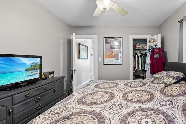 bedroom with a walk in closet, a closet, and ceiling fan