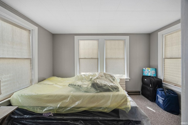 carpeted bedroom featuring multiple windows