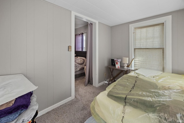 bedroom featuring carpet floors and baseboards