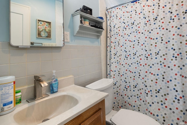 bathroom featuring tile walls, a shower with shower curtain, vanity, and toilet