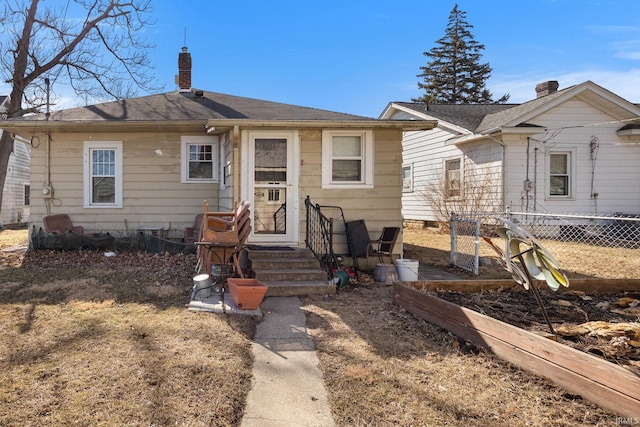 bungalow with fence and a chimney