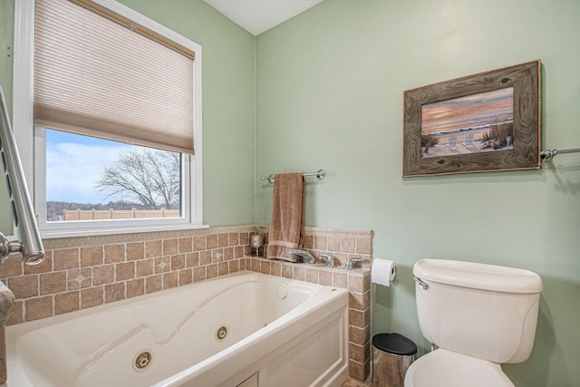 bathroom with toilet and a whirlpool tub