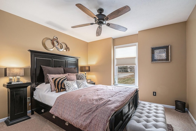 bedroom with light colored carpet, ceiling fan, and baseboards