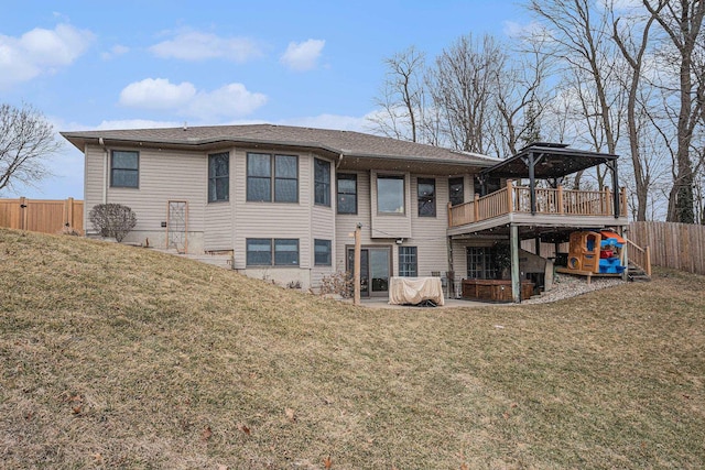 rear view of house featuring a deck, a yard, a patio area, and a fenced backyard