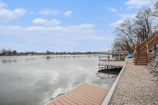 view of dock with a water view, boat lift, and stairway