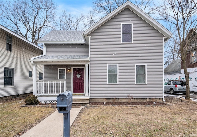 traditional-style home with a porch and a shingled roof