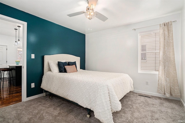 bedroom featuring a ceiling fan, carpet flooring, visible vents, and baseboards