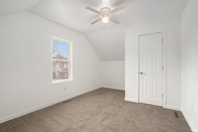 bonus room with vaulted ceiling, carpet floors, ceiling fan, and baseboards