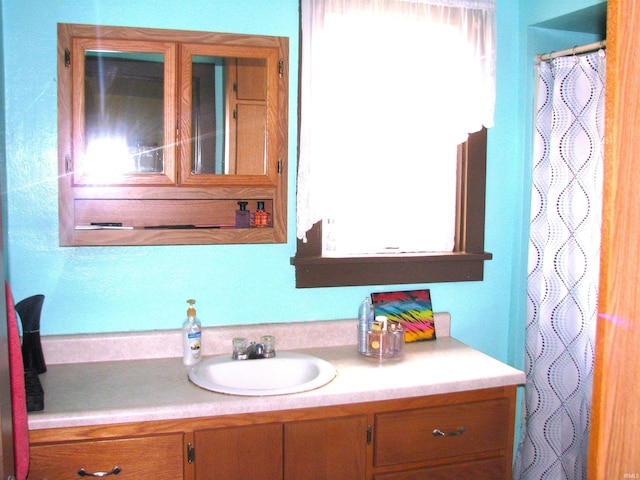 bathroom featuring curtained shower and vanity