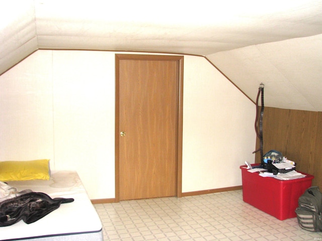 bonus room featuring vaulted ceiling and baseboards