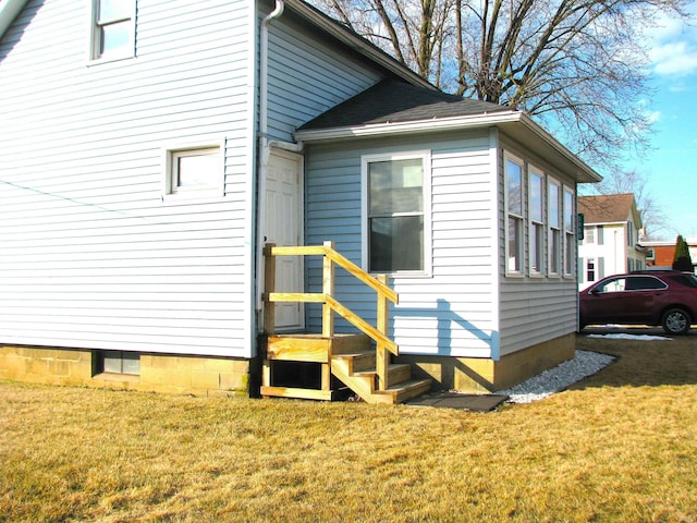 view of side of property with a lawn