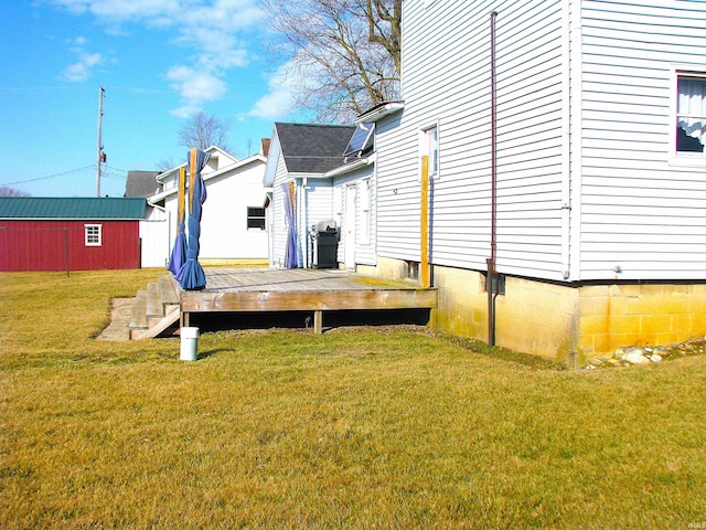 view of yard featuring an outdoor structure and a wooden deck