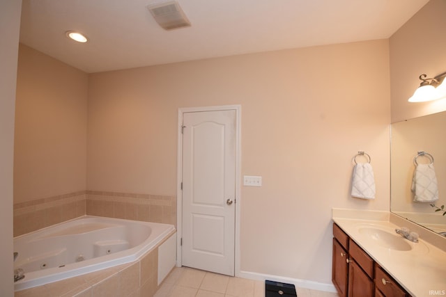 full bath featuring tile patterned flooring, vanity, visible vents, baseboards, and a tub with jets