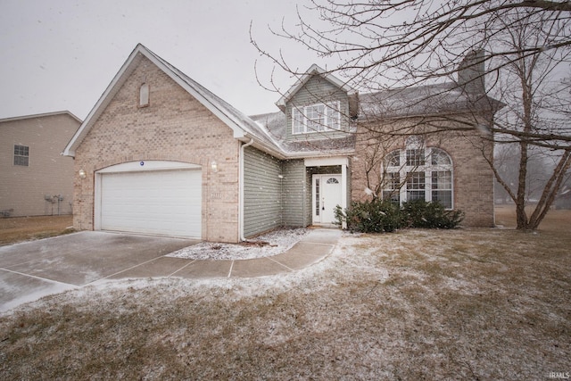 view of front of home with a garage, concrete driveway, and brick siding