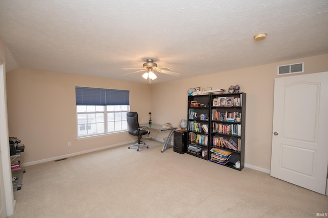 office space with carpet, visible vents, and a textured ceiling