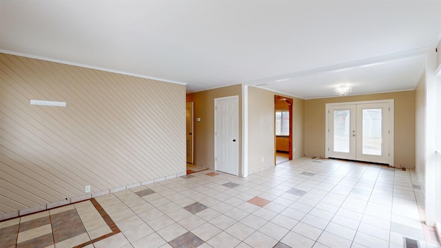 spare room featuring light tile patterned floors, french doors, visible vents, and crown molding