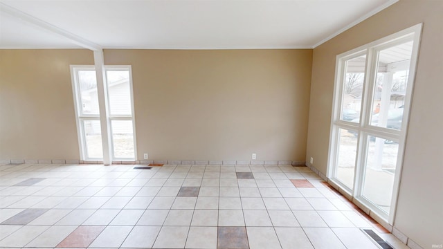 unfurnished room featuring light tile patterned flooring, visible vents, and baseboards