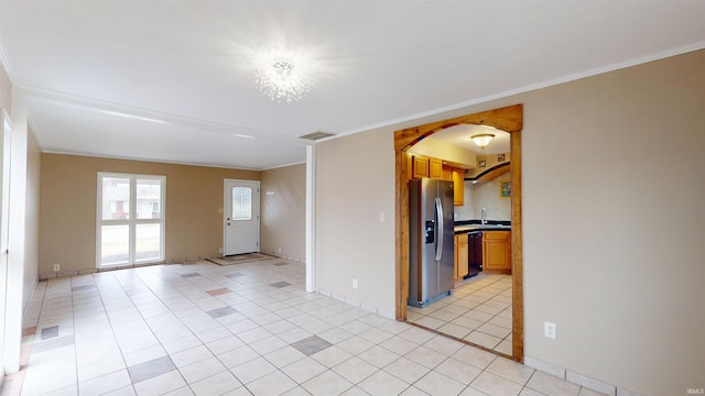 unfurnished room with light tile patterned floors, ornamental molding, a sink, and visible vents