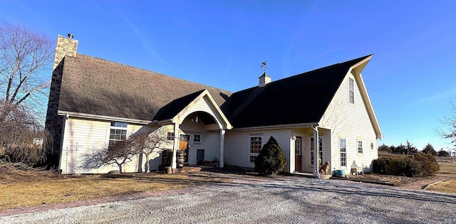 view of front facade featuring a chimney