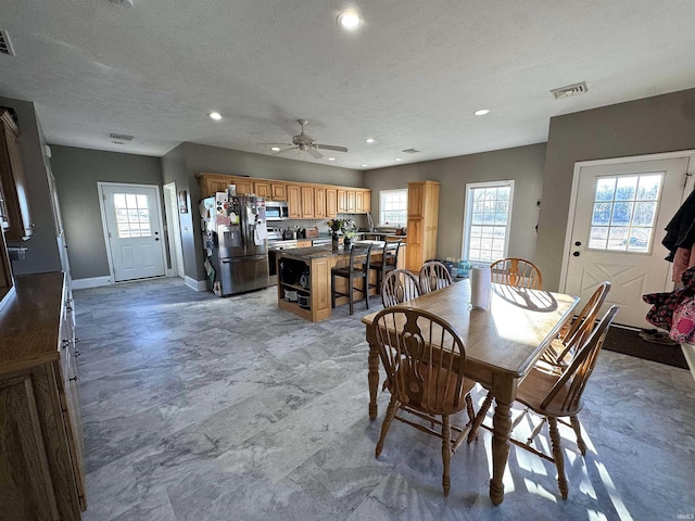 dining area with recessed lighting, plenty of natural light, visible vents, and baseboards