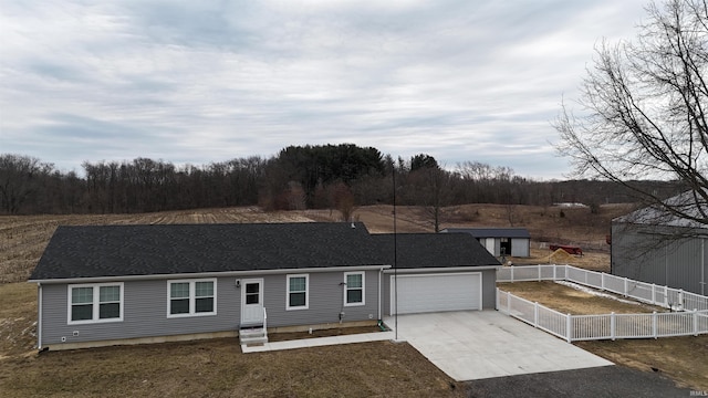 single story home featuring a garage, fence, concrete driveway, and roof with shingles