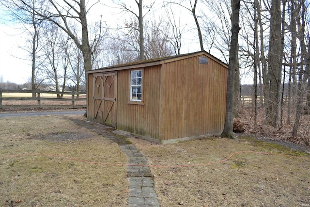 view of shed featuring fence