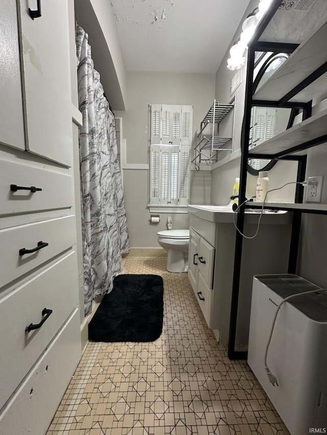 bathroom featuring vanity, toilet, and tile patterned floors