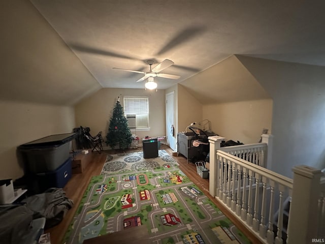 bonus room with a ceiling fan, vaulted ceiling, and wood finished floors