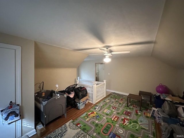 additional living space with ceiling fan, baseboards, vaulted ceiling, and wood finished floors