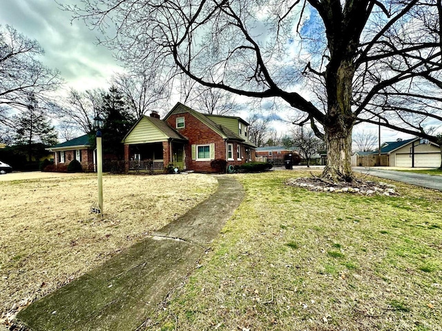 view of front of home featuring a front lawn and brick siding