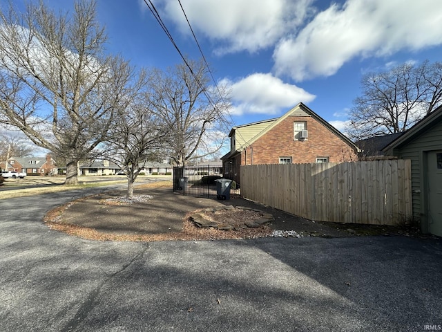 view of home's exterior with brick siding and a fenced front yard