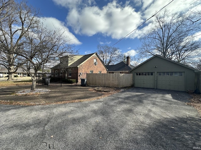 view of home's exterior featuring a fenced front yard and a detached garage